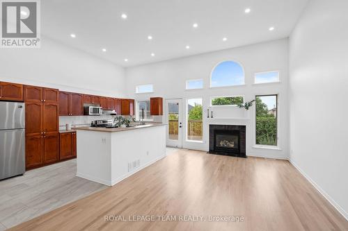 Rear window wall surrounds the gas fireplace - 137 Macassa Circle, Ottawa, ON - Indoor With Fireplace