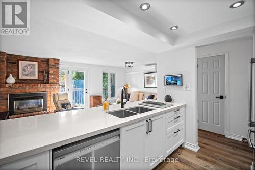 3 - 2058 Brant Street, Burlington, ON - Indoor Photo Showing Kitchen With Fireplace With Double Sink