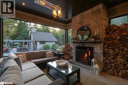 View of patio / terrace featuring an outdoor stone fireplace and outdoor dining space - 