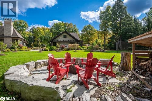 View of grassy yard featuring an outdoor fire pit and a patio - 13160 Nassagaweya Esquesing Townline, Milton, ON - Outdoor