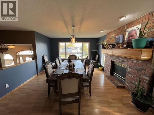 5551 Maxhamish Crescent, Fort Nelson, BC - Indoor Photo Showing Dining Room With Fireplace