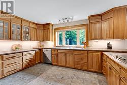 Wrap-about kitchen with rich cherry cabinetry - 