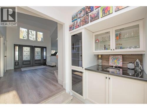 From entry to living room and wet bar - 702 Cypress Drive, Coldstream, BC - Indoor