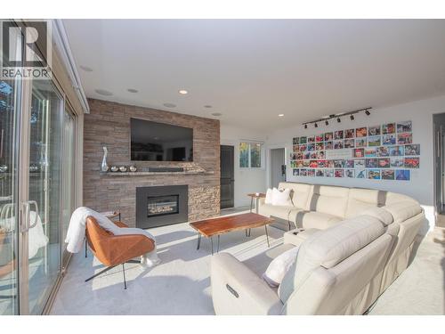 Cozy fireplace - 702 Cypress Drive, Coldstream, BC - Indoor Photo Showing Living Room With Fireplace