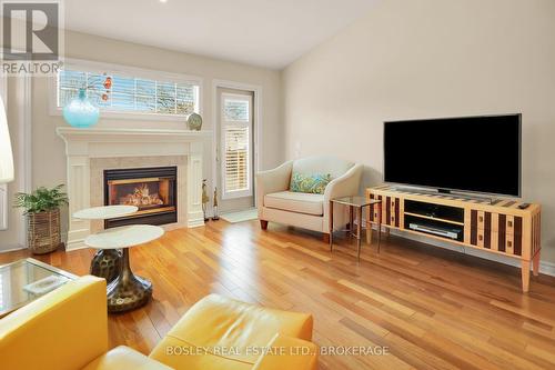 ACCESS TO BACK DECK AND BACKYARD... - 3 - 21 Loretta Drive W, Niagara-On-The-Lake (Virgil), ON - Indoor Photo Showing Living Room With Fireplace