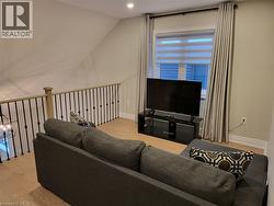 Living room featuring light wood finished floors and lofted ceiling - 