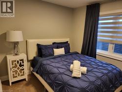 Bedroom with wood finished floors and baseboards - 