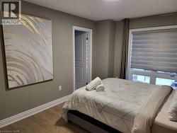 Bedroom with wood finished floors and baseboards - 