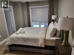 Bedroom with wood finished floors and baseboards - 