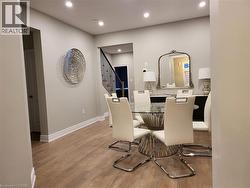 Dining room featuring light wood-style floors, recessed lighting, and stairs - 