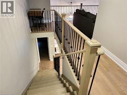 Staircase featuring wood finished floors and baseboards - 