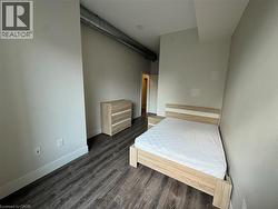Bedroom with dark wood finished floors and baseboards - 