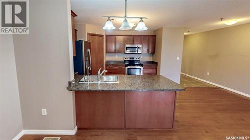 108 3730 Eastgate Drive E, Regina, SK - Indoor Photo Showing Kitchen With Stainless Steel Kitchen With Double Sink