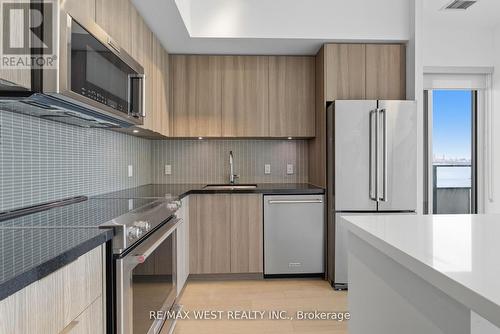 702 - 20 Shore Breeze Drive, Toronto, ON - Indoor Photo Showing Kitchen With Upgraded Kitchen