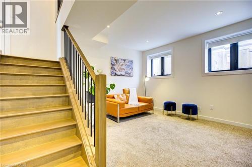 Living area with light carpet, stairs, and recessed lighting - 847 Stedwell Street, London, ON - Indoor Photo Showing Other Room