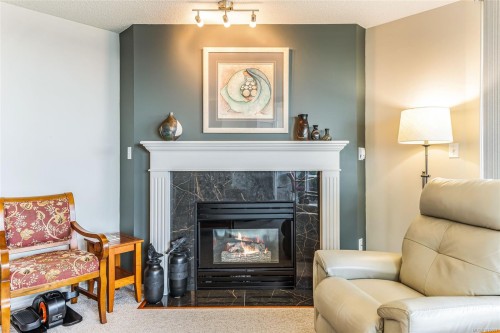 207-150 Promenade Dr, Nanaimo, BC - Indoor Photo Showing Living Room With Fireplace