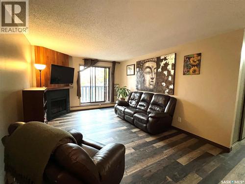 308 1140 9Th Avenue Ne, Swift Current, SK - Indoor Photo Showing Living Room With Fireplace