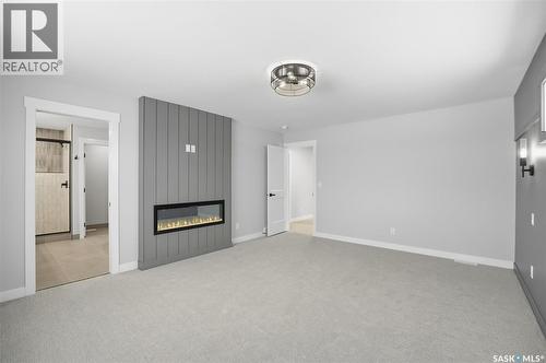 166 Cockroft Manor, Saskatoon, SK - Indoor Photo Showing Other Room With Fireplace