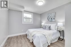 Bedroom with baseboards and light wood-type flooring - 