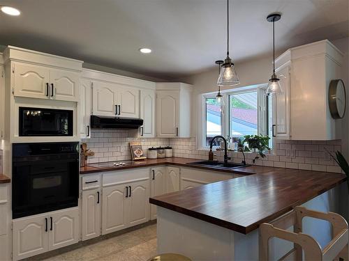 408 Dixie Road, Swan River, MB - Indoor Photo Showing Kitchen With Double Sink