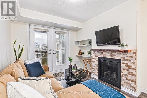 205 - 2 Cove Court, Collingwood, ON - Indoor Photo Showing Living Room With Fireplace
