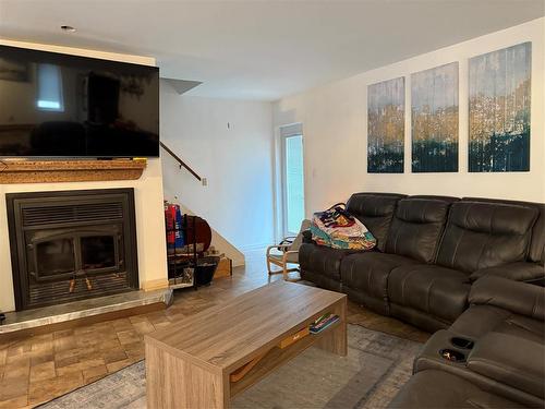 405 Gadwell Place, Duck Mountain Provincial Park, MB - Indoor Photo Showing Living Room With Fireplace