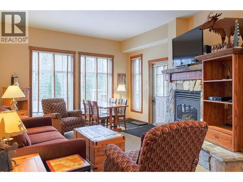 5258 Highline Drive Unit# 122, Fernie, BC - Indoor Photo Showing Living Room With Fireplace