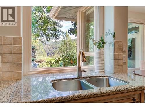 Dual SS sinks overlooking back yard - 3875 Gallaghers Parkway, Kelowna, BC - Indoor Photo Showing Kitchen With Double Sink