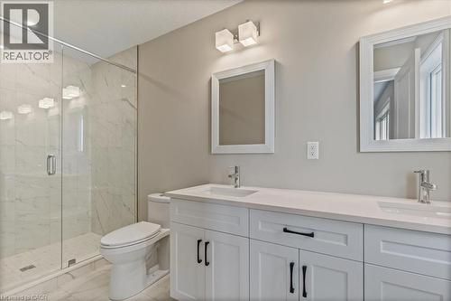 Full bath with a marble finish shower, double vanity, and light marble finish floors - 256 Keeso Lane, Listowel, ON - Indoor Photo Showing Bathroom