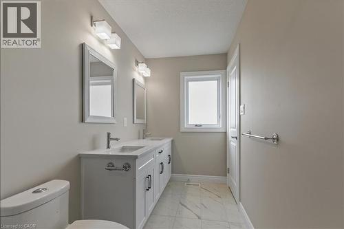 Bathroom with light marble finish floors and double vanity - 256 Keeso Lane, Listowel, ON - Indoor Photo Showing Bathroom