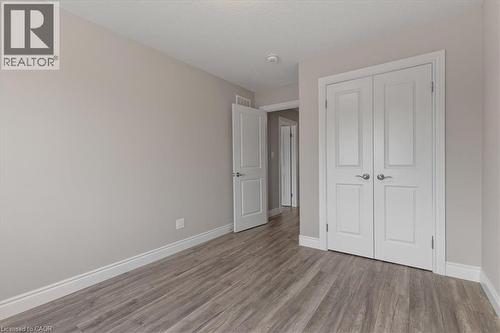 Unfurnished bedroom featuring wood finished floors and a closet - 256 Keeso Lane, Listowel, ON - Indoor Photo Showing Other Room
