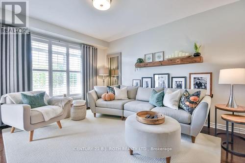Large windows adorn this trendsetting Family Room - 63 The Queensway, Barrie, ON - Indoor Photo Showing Living Room