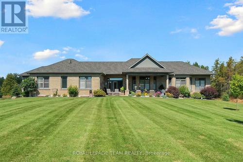 Low maintenance perennials grace the rear patio - 217 Shamus Way, Ottawa, ON - Outdoor With Deck Patio Veranda With Facade
