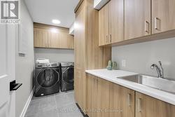 Lower level Laundry w/tons of storage & SS sink. - 