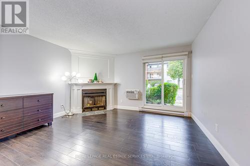911 - 1450 Glen Abbey Gate, Oakville, ON - Indoor Photo Showing Living Room With Fireplace