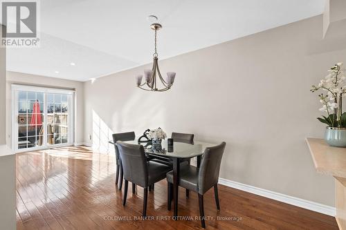 Dining room w chandelier hanging above. - 20 Fieldberry Private, Ottawa, ON - Indoor Photo Showing Dining Room