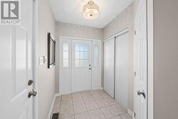 Welcoming, tiled front foyer w closet space. - 
