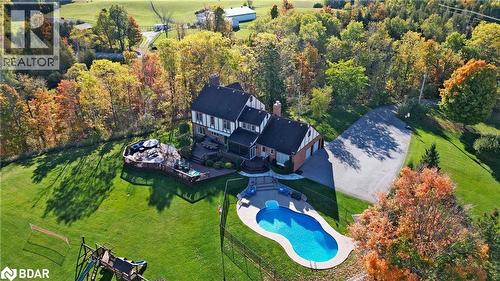 Kitchen with gray cabinetry, appliances with stainless steel finishes, tasteful backsplash, wooden counters, and a breakfast bar area - 4905 First Line, Erin, ON - Indoor Photo Showing Kitchen With Double Sink