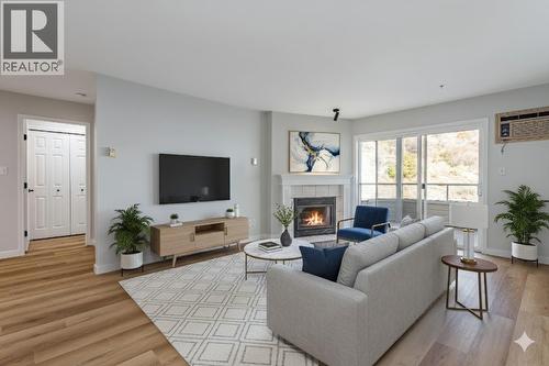 Virtually Staged with AI - 3806 35 Avenue Unit# 309, Vernon, BC - Indoor Photo Showing Living Room With Fireplace