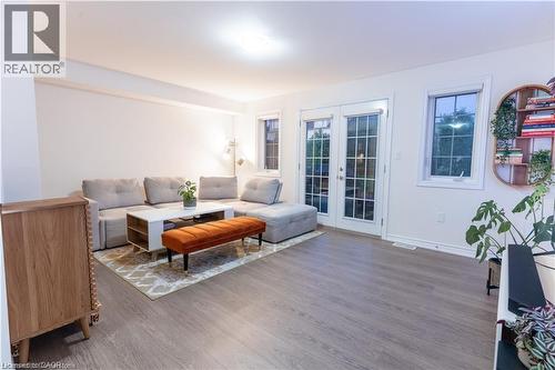 Living area featuring french doors and wood finished floors - 85 Mullin Drive Unit# 20B, Guelph, ON - Indoor Photo Showing Living Room