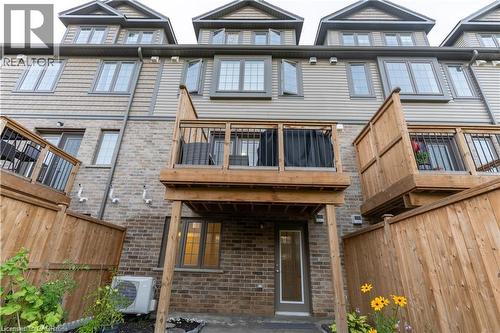Back of house with a fenced backyard, brick siding, and a patio area - 85 Mullin Drive Unit# 20B, Guelph, ON - Outdoor With Deck Patio Veranda With Facade