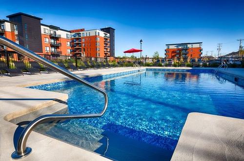 Pool - 403-3725 Av. Jean-Béraud, Laval (Chomedey), QC - Outdoor With In Ground Pool
