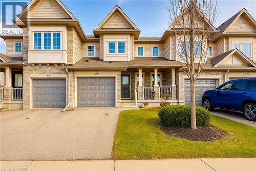 Craftsman-style home with stone siding, a porch, a front yard, and driveway - 6 Upper Mercer Street Unit# B6, Kitchener, ON - Outdoor With Facade