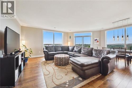 Living room featuring crown molding, hardwood / wood-style flooring, and rail lighting - 255 Keats Way Unit# 1303, Waterloo, ON - Indoor Photo Showing Living Room