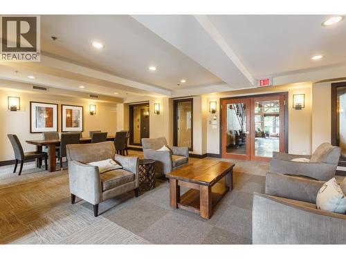 Community lounge over looking pool with fitness room located above - 1099 Sunset Drive Unit# 432, Kelowna, BC - Indoor Photo Showing Living Room