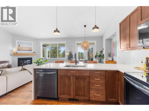 2555 Tallus Ridge Drive, West Kelowna, BC - Indoor Photo Showing Kitchen With Fireplace