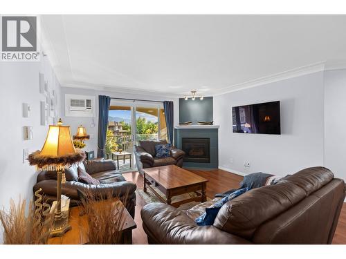 1964 Enterprise Way Unit# 403, Kelowna, BC - Indoor Photo Showing Living Room With Fireplace