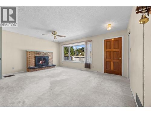 Upstairs Living Room Unstaged - 10212 Happy Valley Road, Summerland, BC - Indoor Photo Showing Living Room With Fireplace