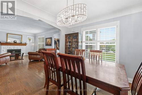 Dining Area with Hardwood Floor Open to Living Rm - 677 Greenwood Drive, Burlington, ON - Indoor Photo Showing Dining Room With Fireplace