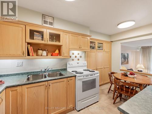 Beautiful Glass Cabinetry - 308 - 250 Scarlett Road, Toronto, ON - Indoor Photo Showing Kitchen With Double Sink